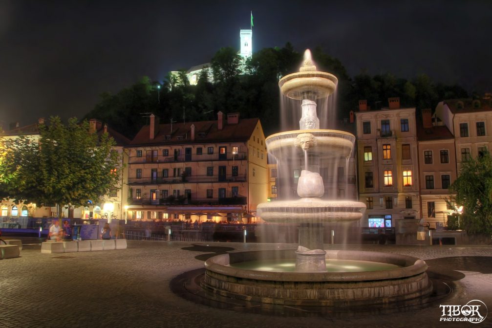 A fountain on the Breg Embankment at the Novi Trg square in the centre of Ljubljana at night