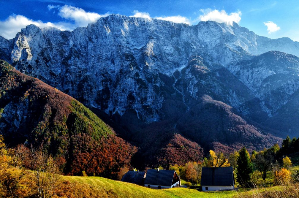 View of the Loska Stena wall above the Strmec village in the Julian Alps in autumn