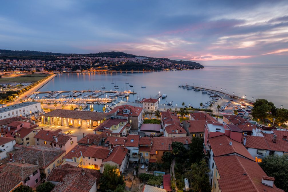 Koper Old Town with the harbor and the modern part of the city with Semedela, Markovec and Zusterna in the background