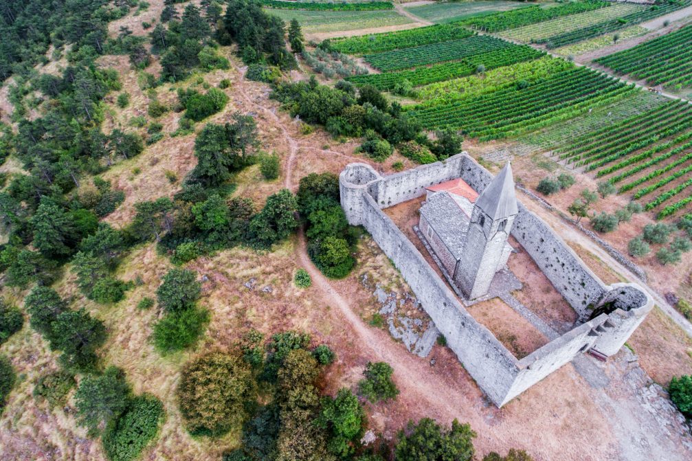 Aerial view of the fortified Church of the Holy Trinity in Hrastovlje, Slovenia
