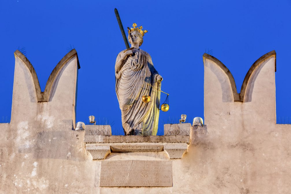 Central statue of Lady Justice on top of the Praetorian palace in Koper, Slovenia