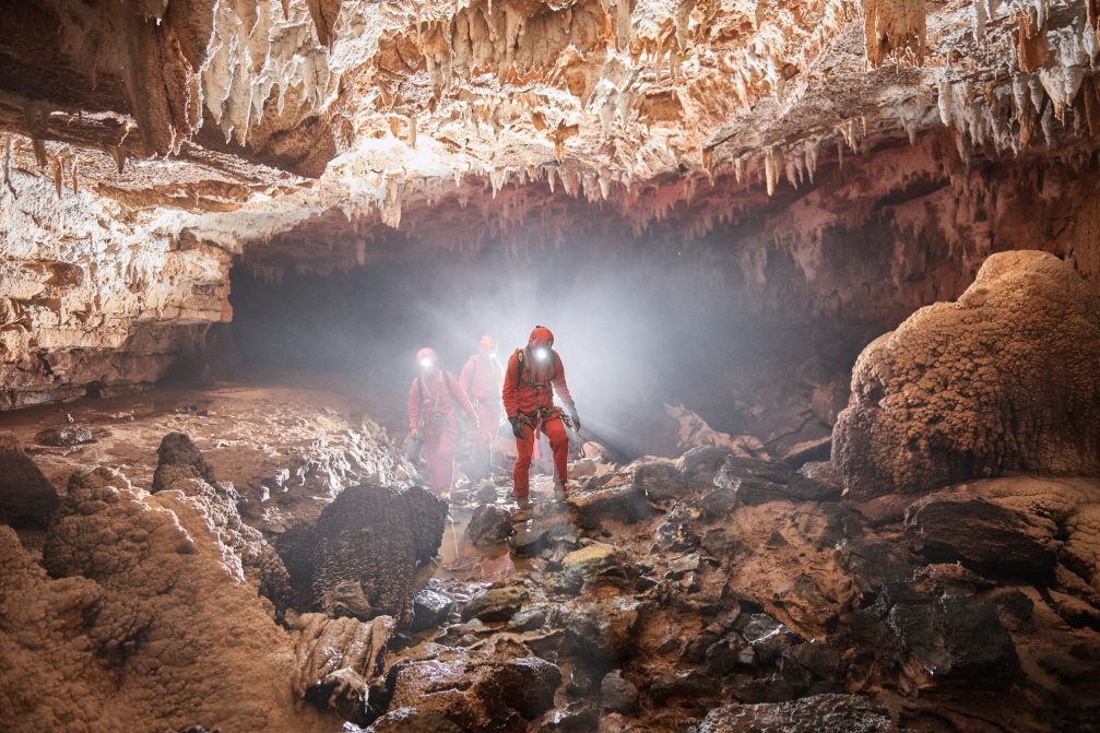 A group of people exploring the Pivka Cave in Postojna Caves, Slovenia