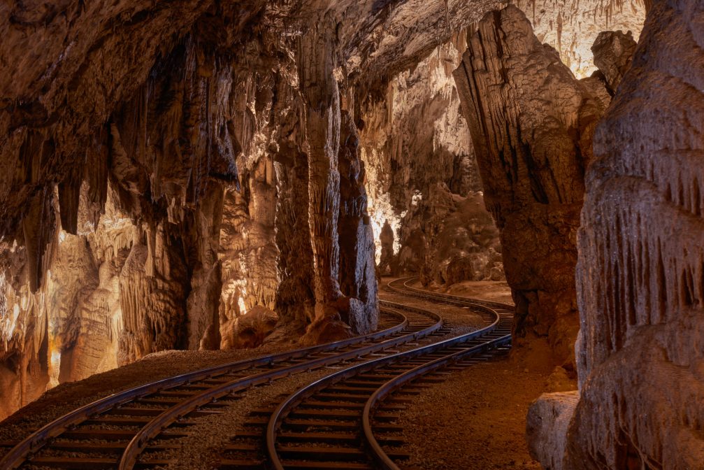 Train rails inside the Postojna Cave in Slovenia