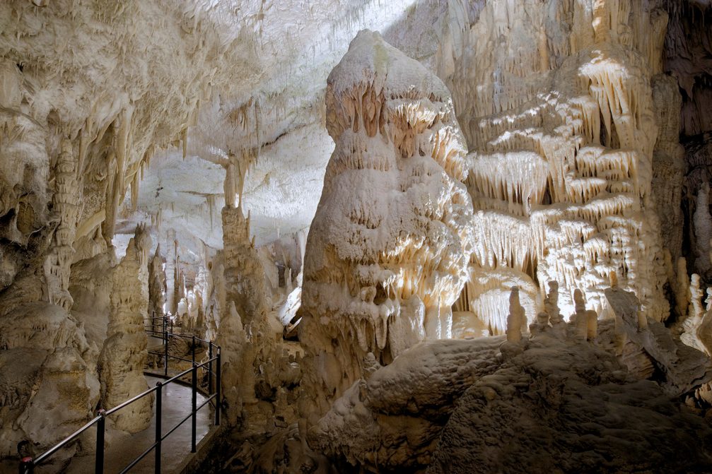 A path leading through the White Hall inside Postojna Caves in Slovenia