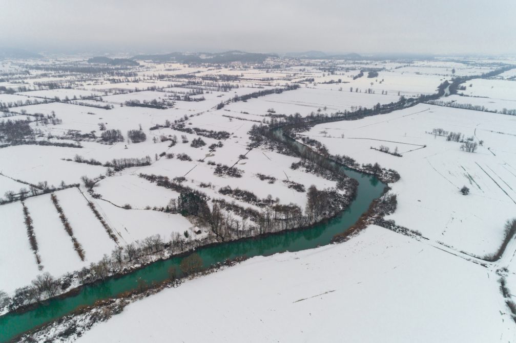 Elevated view of the Ljubljanica river flowing through the Ljubljana Marshes in winter