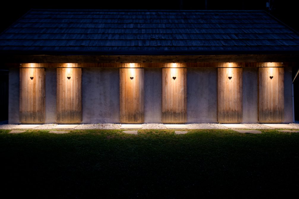 A hut at Glamping Gozdne Vile with doors that have a heart-shaped opening