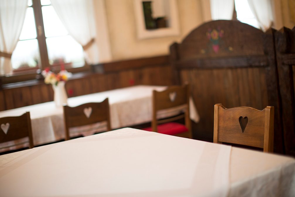 Chairs in a restaurant in Slovenia with a heart-shaped opening carved through the back