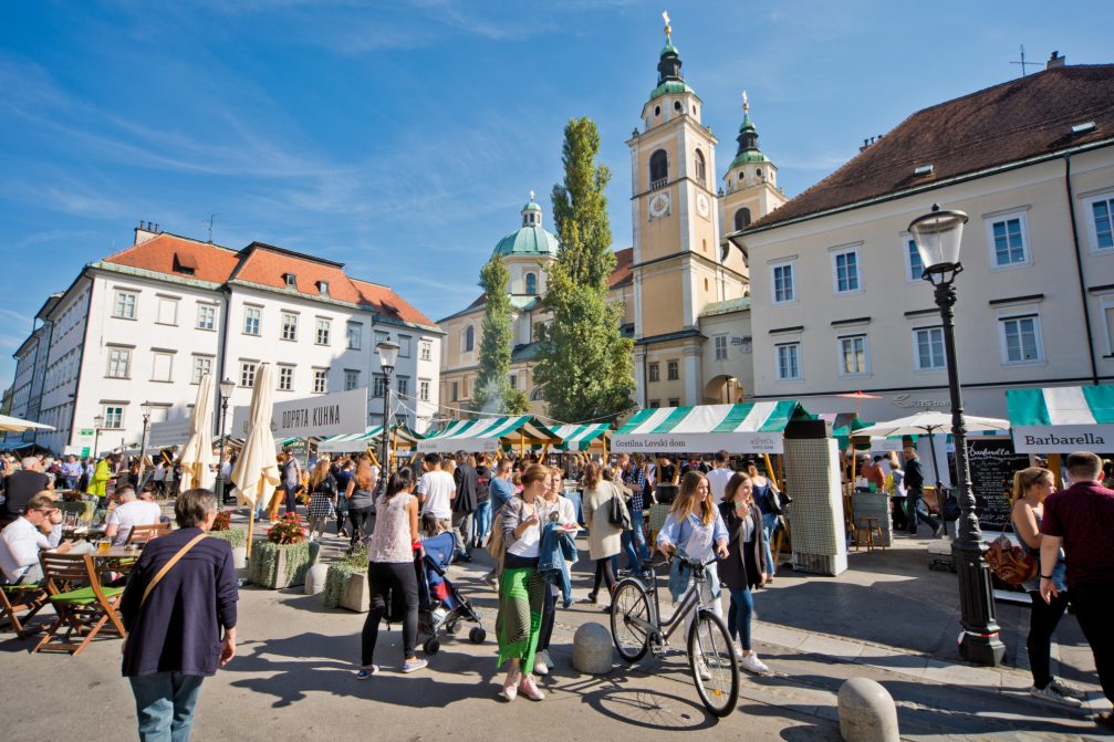 A group of visitors at the Open Kitchen gourmet street food market in Ljubljana