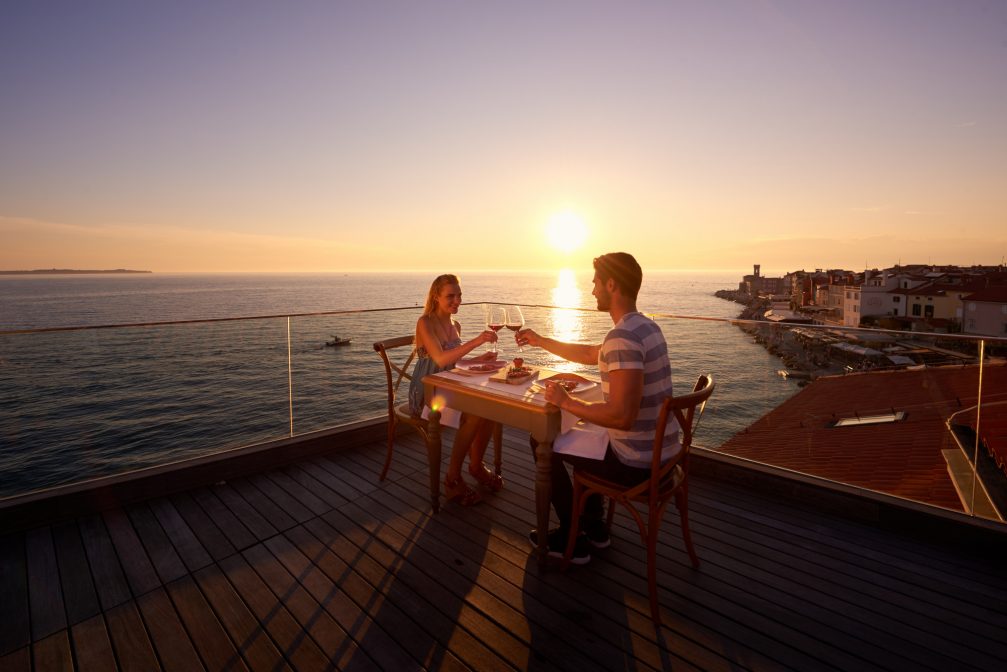 A couple having a romantic dinner in Piran, Slovenia