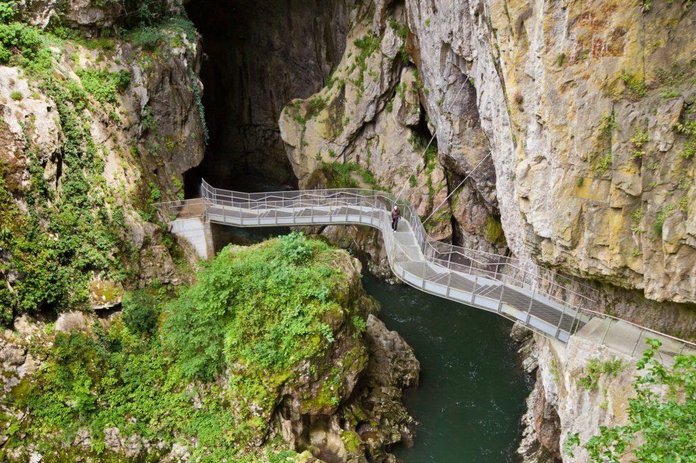 A bridge over the Reka river leading to the entrance of the Skocjan Caves in Slovenia