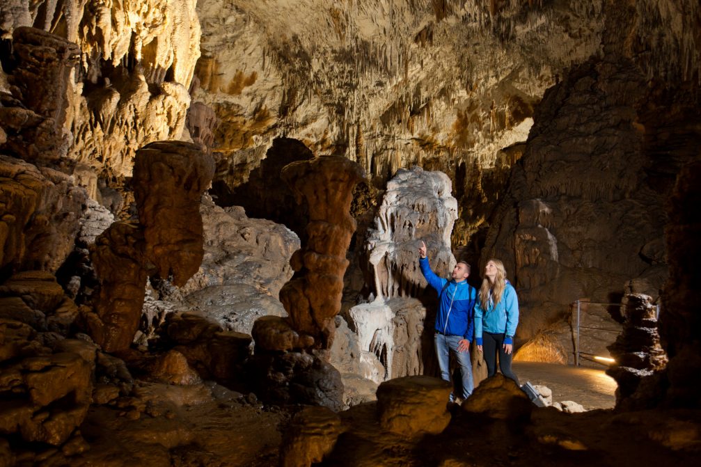 Visitors looking at various rock formations inside the Skocjan Caves in Slovenia