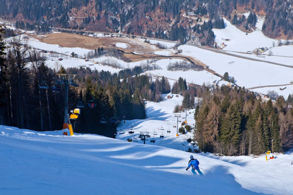 A skier skiing at the Podkoren Slope at Kranjska Gora Ski Resort in Slovenia