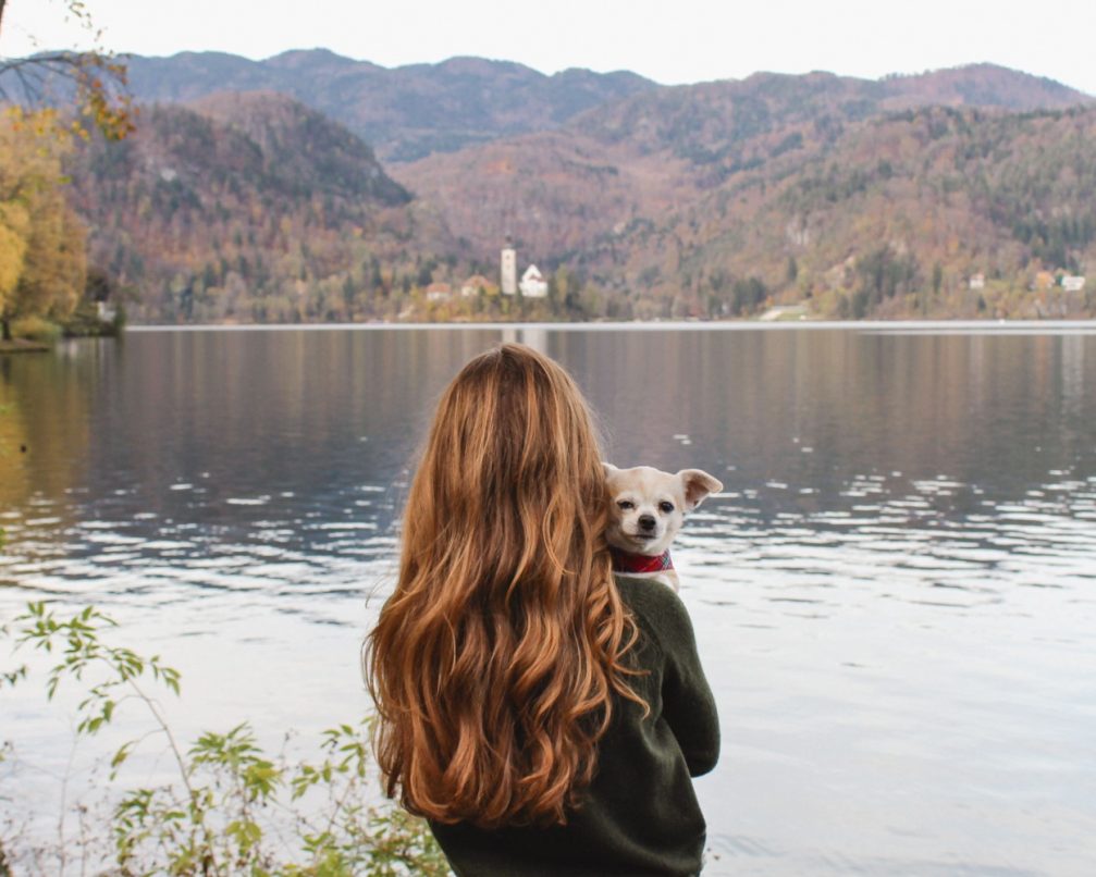 Scarlett Miers From Petite Suitcase and her dog, Alfie, at Lake Bled