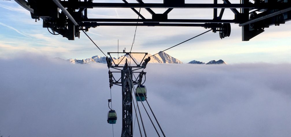 Gondola lifts at Kanin Sella Nevea Ski Resort with mountains in the background