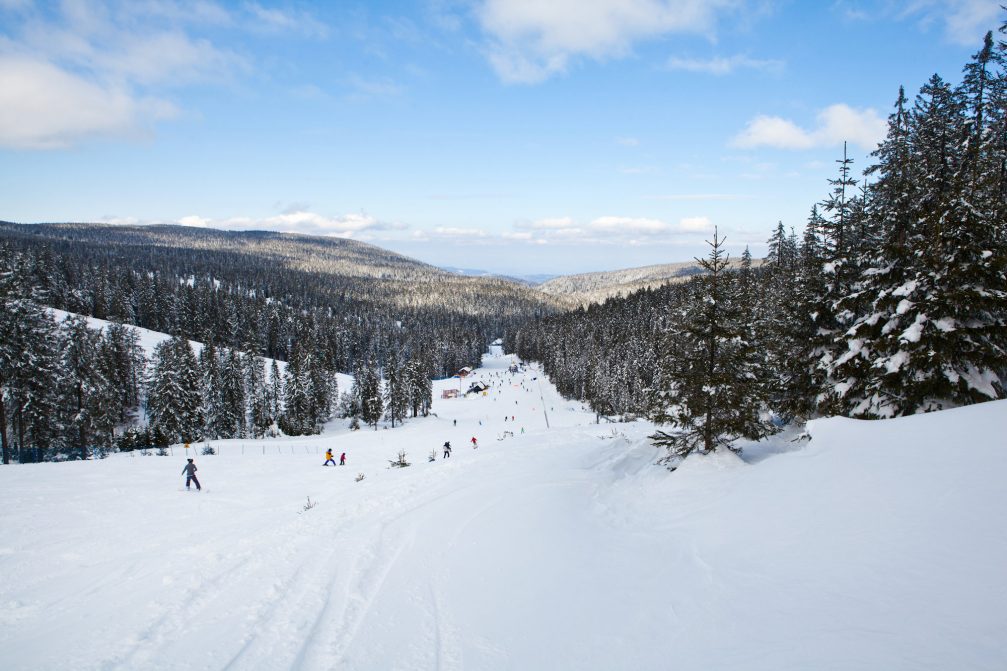 A group of skiers skiing down the slopes of Rogla Ski Resort in Slovenia