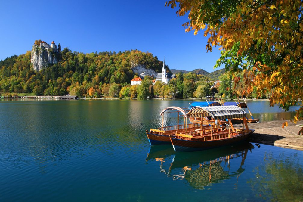 Pleatna boats at Lake Bled with Bled Castle in the background