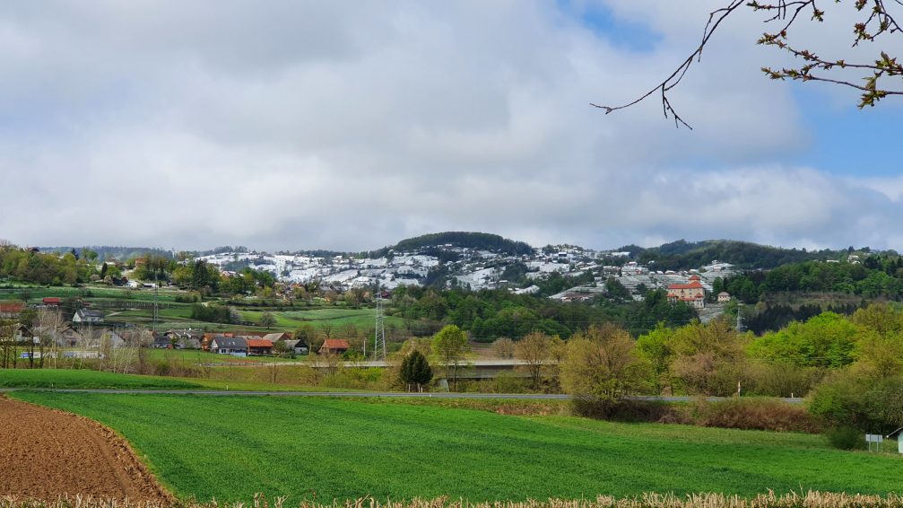 Slovenian countryside in spring with snow covered hills in the background