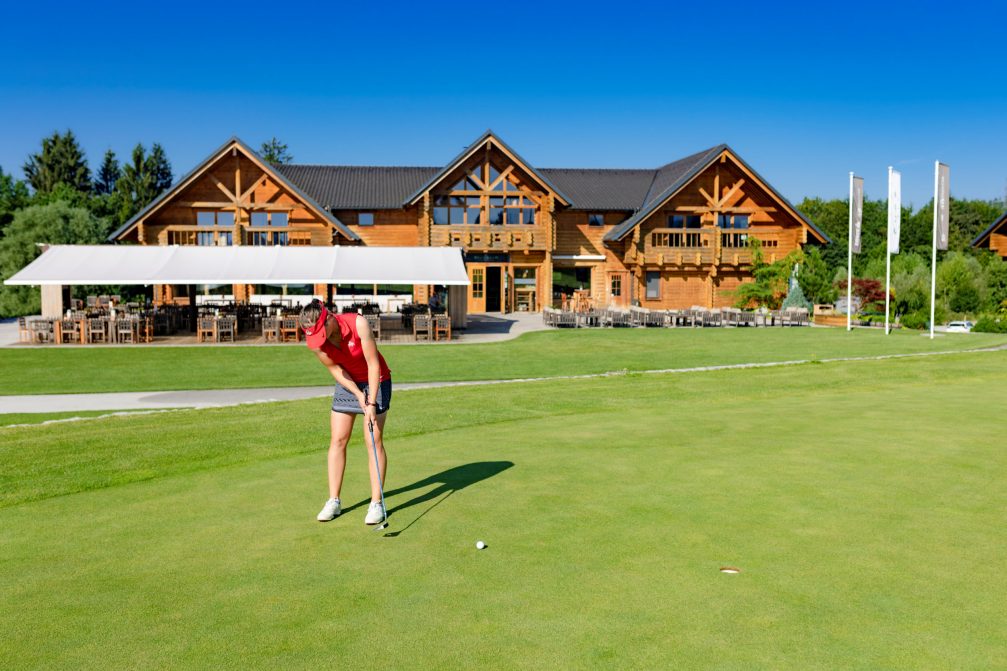 Exterior of the log cabin style clubhouse at Diners CUBO Ljubljana Golf Course in Slovenia