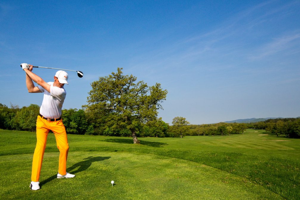 Male golfer teeing off at Lipica Golf Course in Slovenia