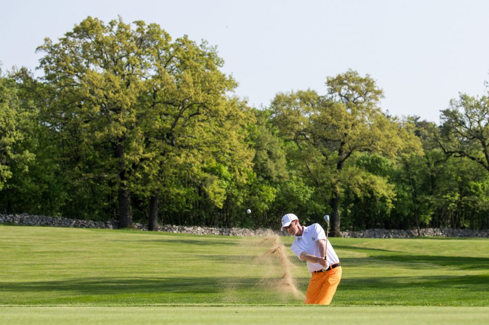 A golfer shot ball from sand bunker at Lipica Golf Course in Slovenia