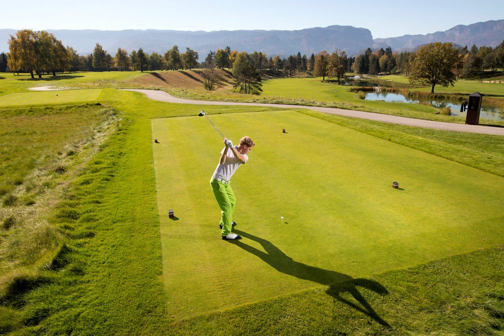 Golfer hitting golf shot at Kings Course at Royal Bled Golf in Slovenia