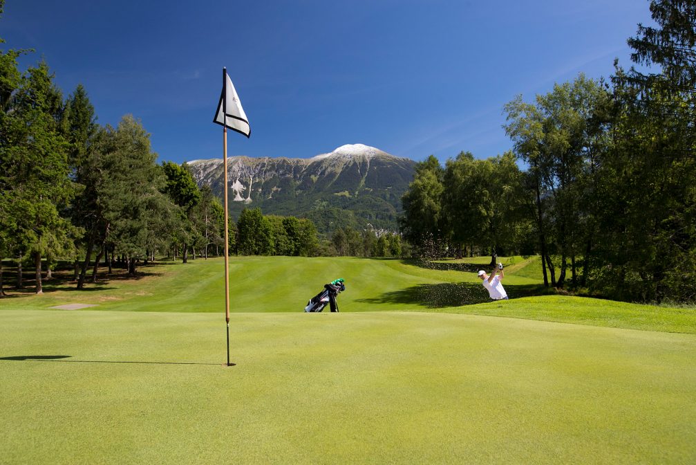 Male golfer shooting a golf ball at Kings Course at Royal Bled Golf in Slovenia