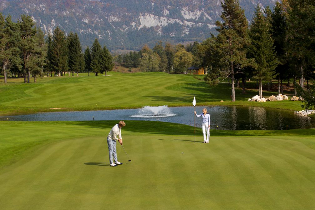 A golfer putting at Kings Course at Royal Bled Golf in Slovenia