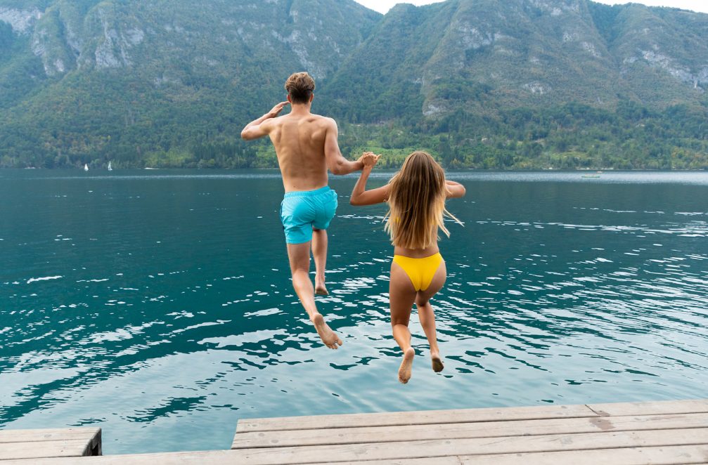A couple swimming in Lake Bohinj in Triglav National Park in Slovenia