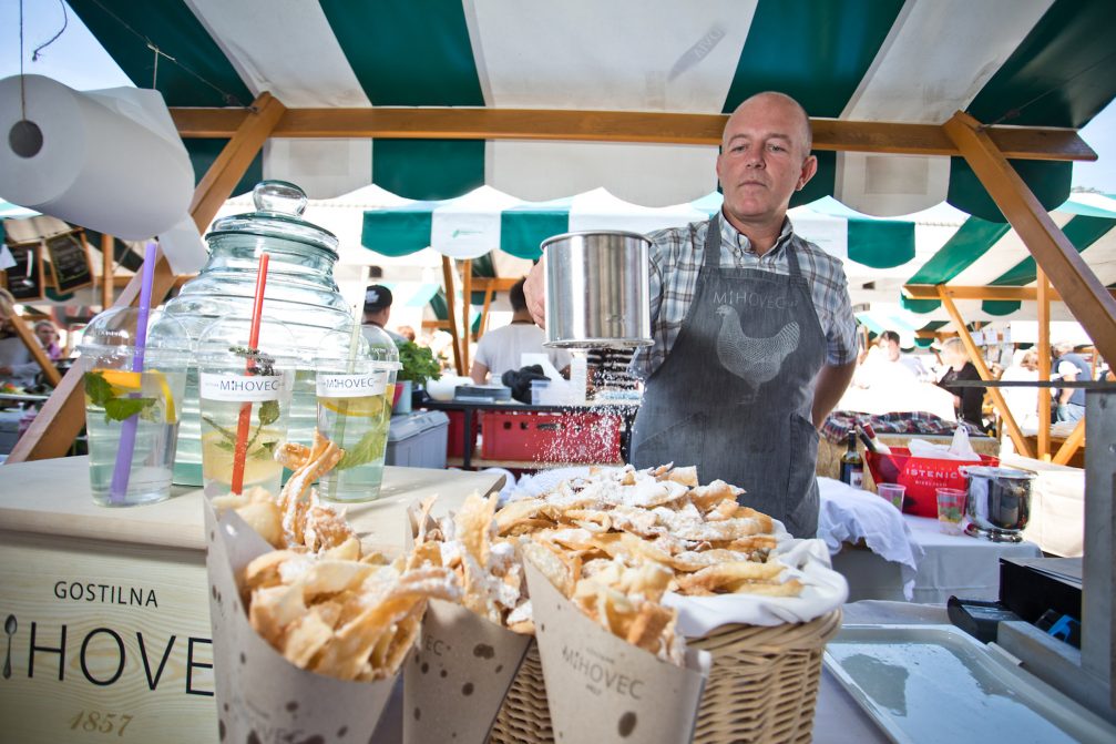 Preparing food at Open Kitchen gourmet open air food market in Ljubljana