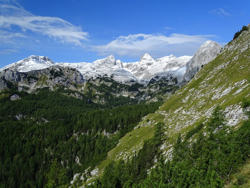 View of Julian Alps from the trail that winds across steep slopes of Mount Tosc