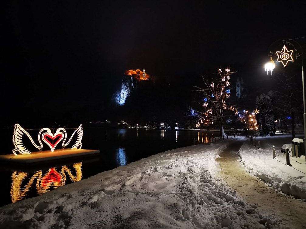 Christmas light displays at Lake Bled in Slovenia with the castle in the background