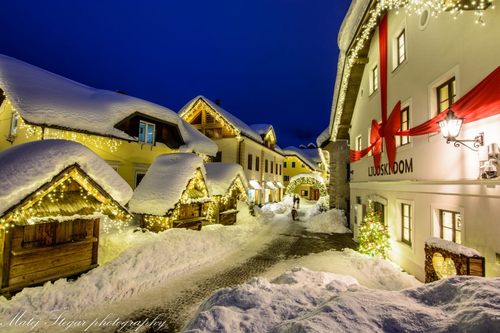 Village of Kranjska Gora covered in snow at night in the holiday season