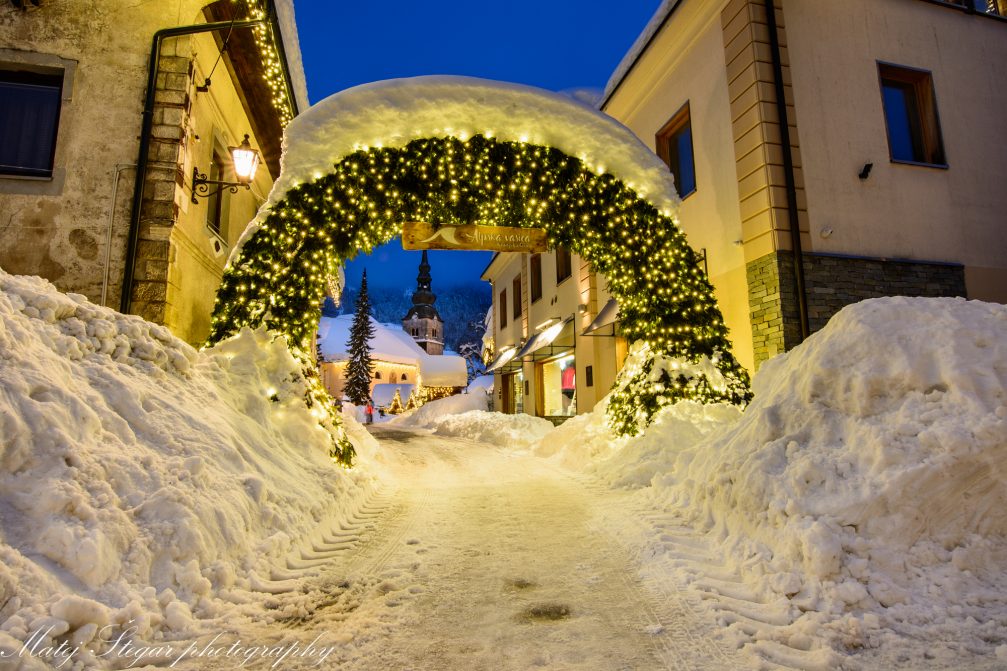 Village of Kranjska Gora covered in snow at night in winter