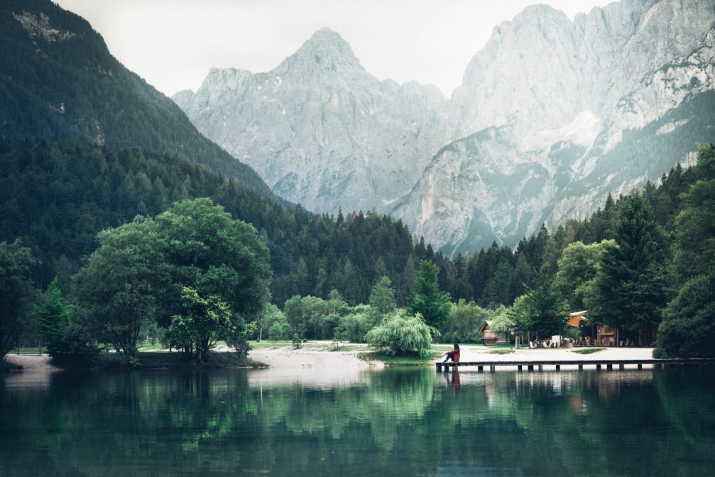 The calm Lake Jasna with mountains of Slovenian Alps in the background