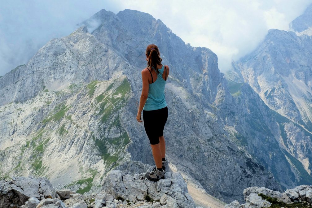 A female hiker looking towards Mt. Planjava in Kamnik-Savinja Alps