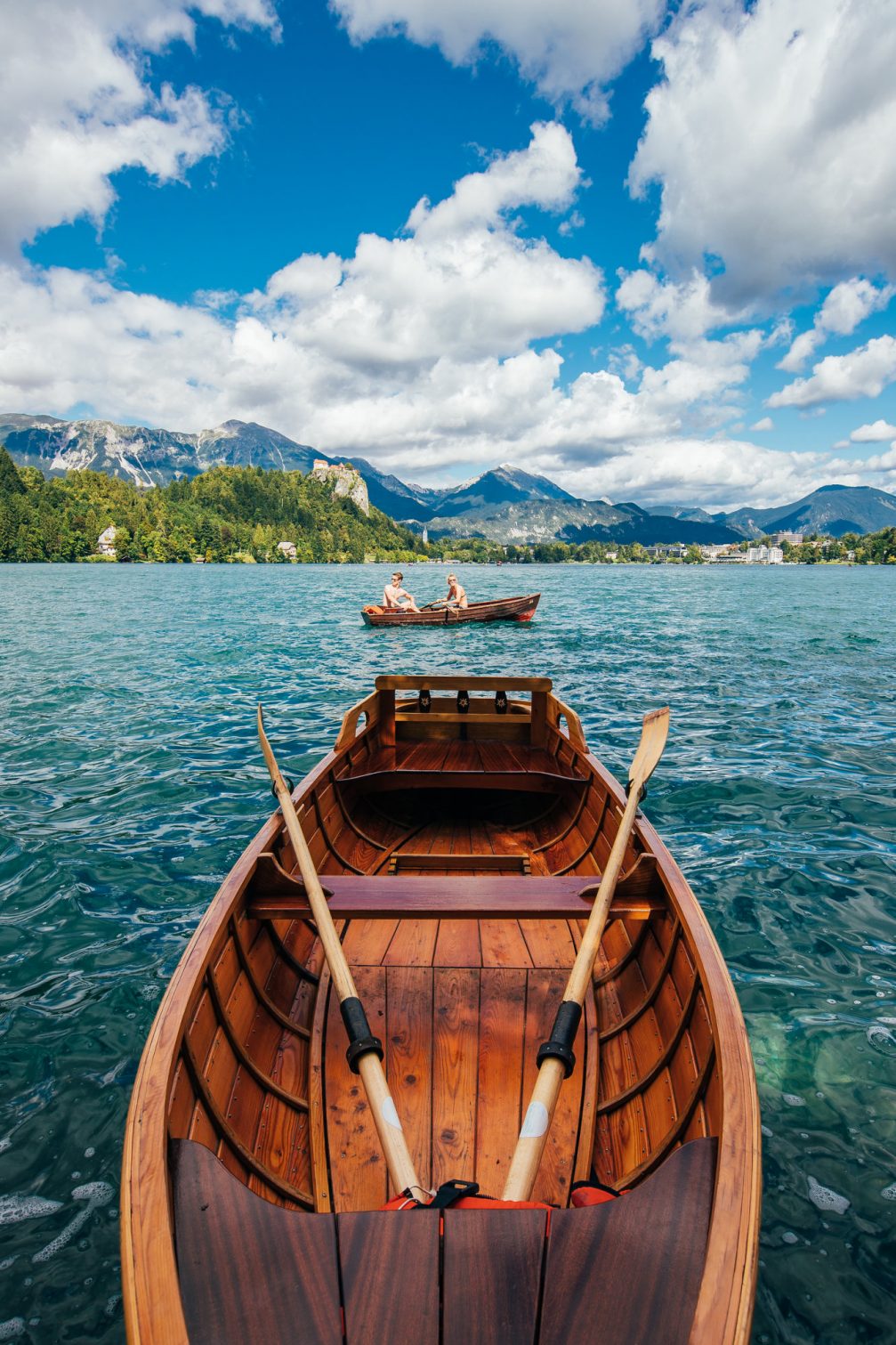 View of Bled Castle from a wooden rowboat on Lake Bled in Slovenia