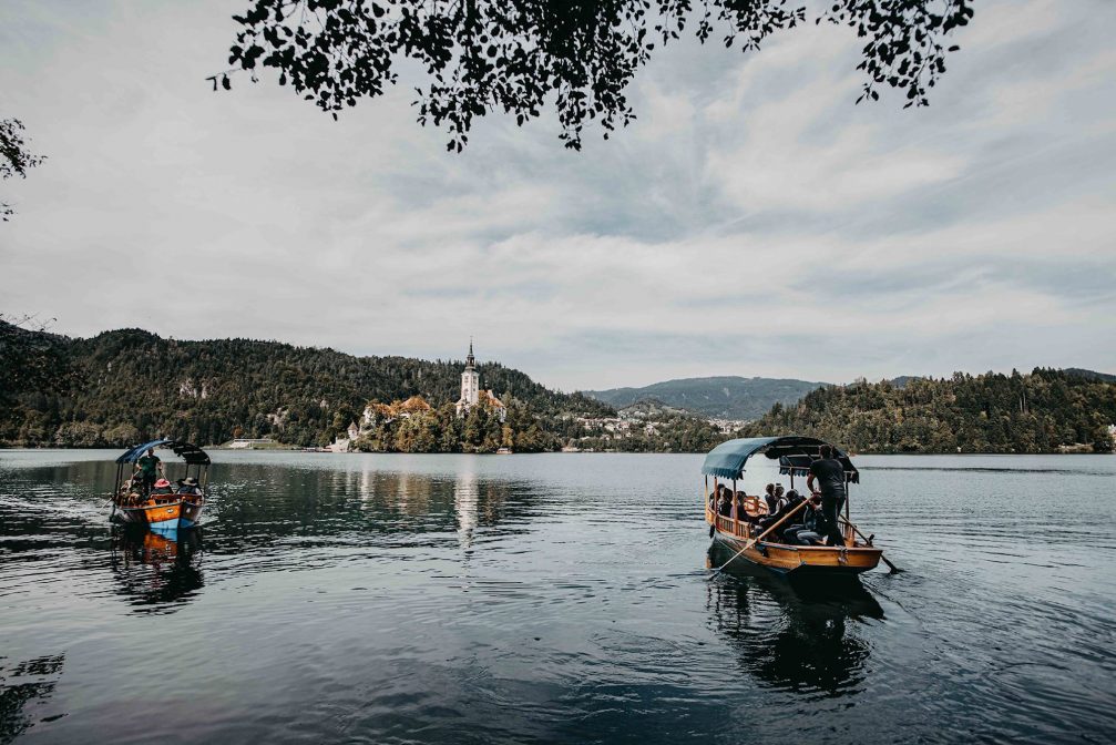 Pletna Boats on Lake Bled driving tourists towards Bled Island