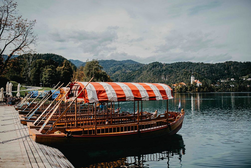 Traditional pletna boats on Lake Bled with the Church on Bled Island in the background