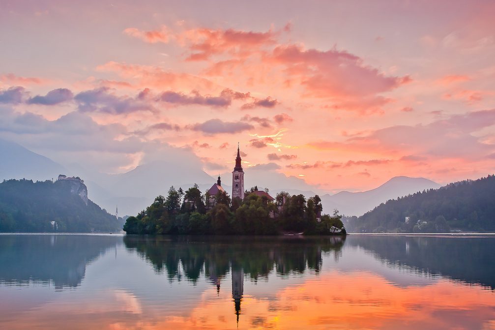 Bled Island at sunrise with vivid orange and purple colours