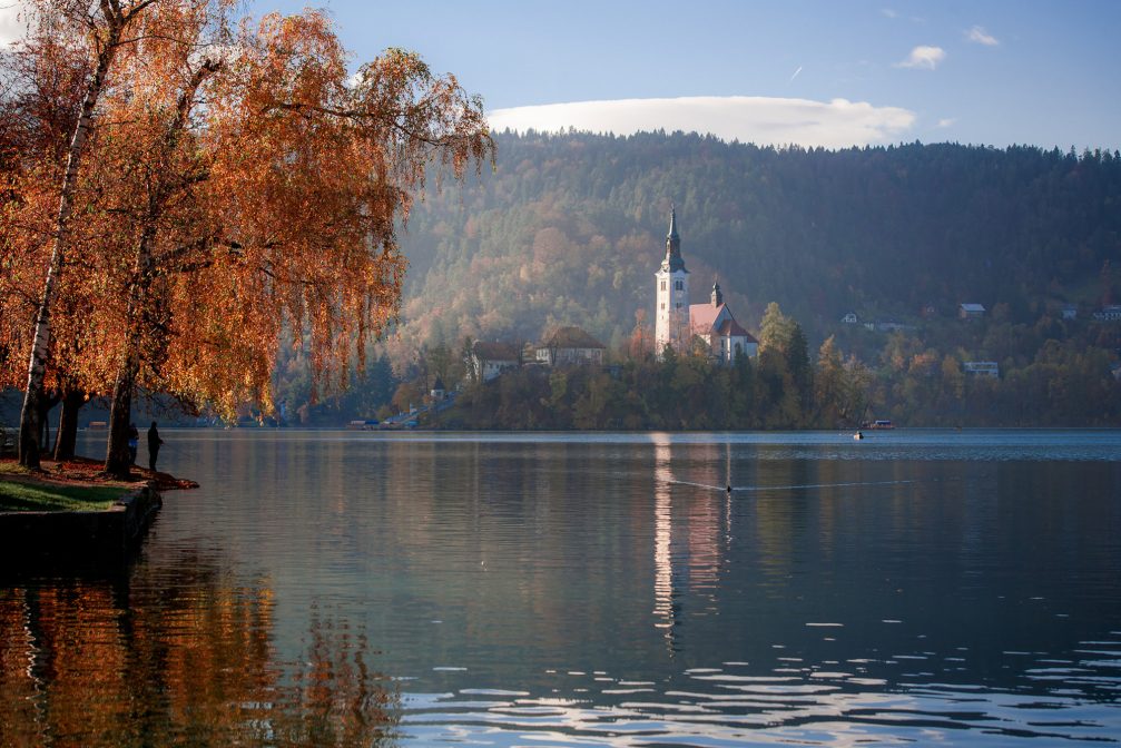 View of Bled Island from the shore of Lake Bled in the autumn season