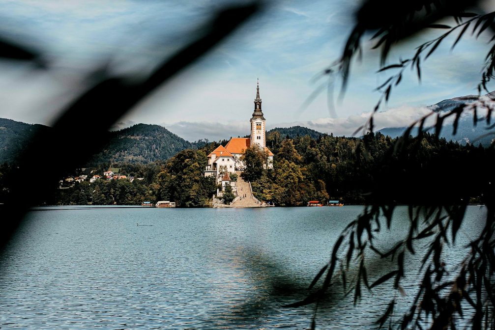 View of the Church on Bled Island through tree branches