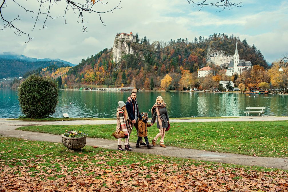 A family walking around Lake Bled in the autumn season