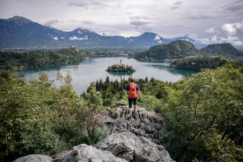 A hiker looking towards Bled Island in the middle of Lake Bled
