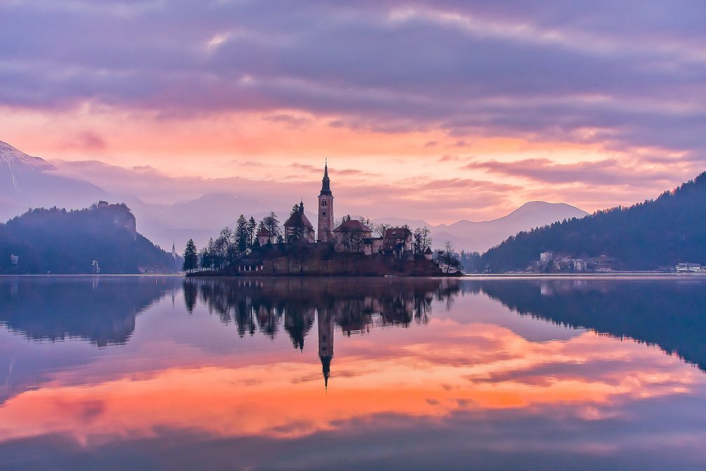 Lake Bled and its island with a church at sunrise