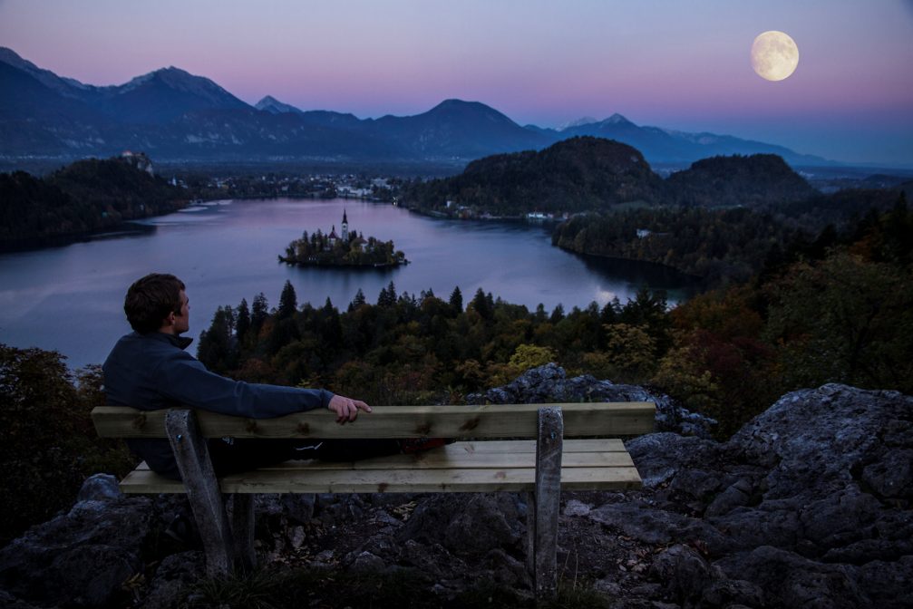 View of Lake Bled from Ojstrica Viewpoint at night with a Moon on the sky