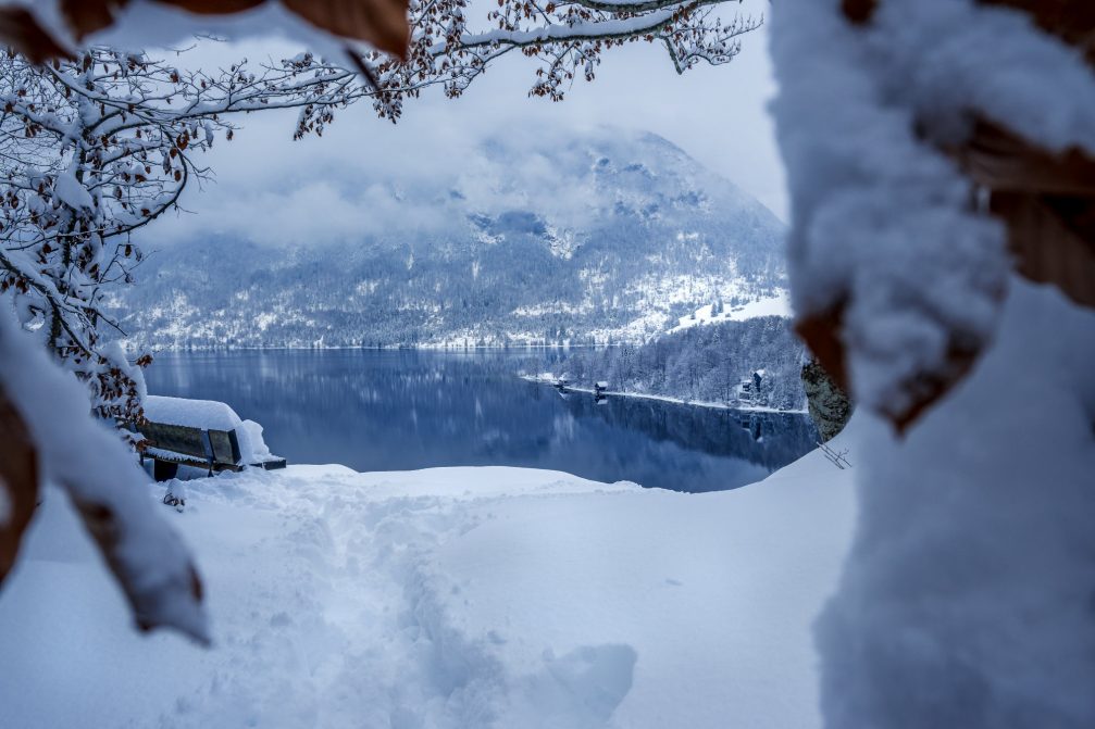 Aerial view of Lake Bohinj covered in snow the next day after snowfall