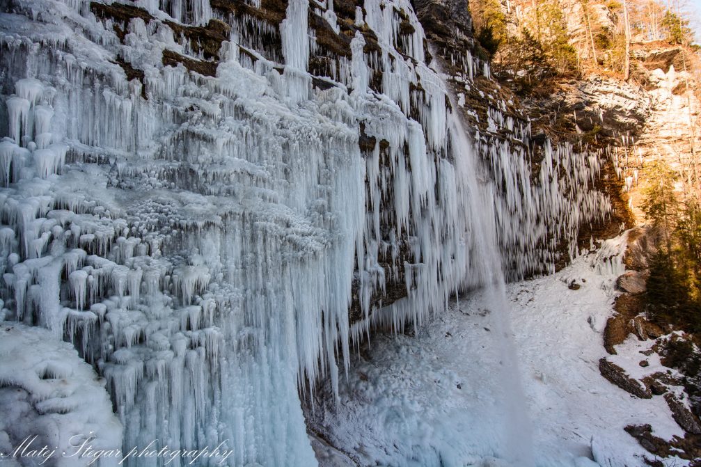 Wall of icicles around Waterfall Pericnik in Triglav National Park in winter