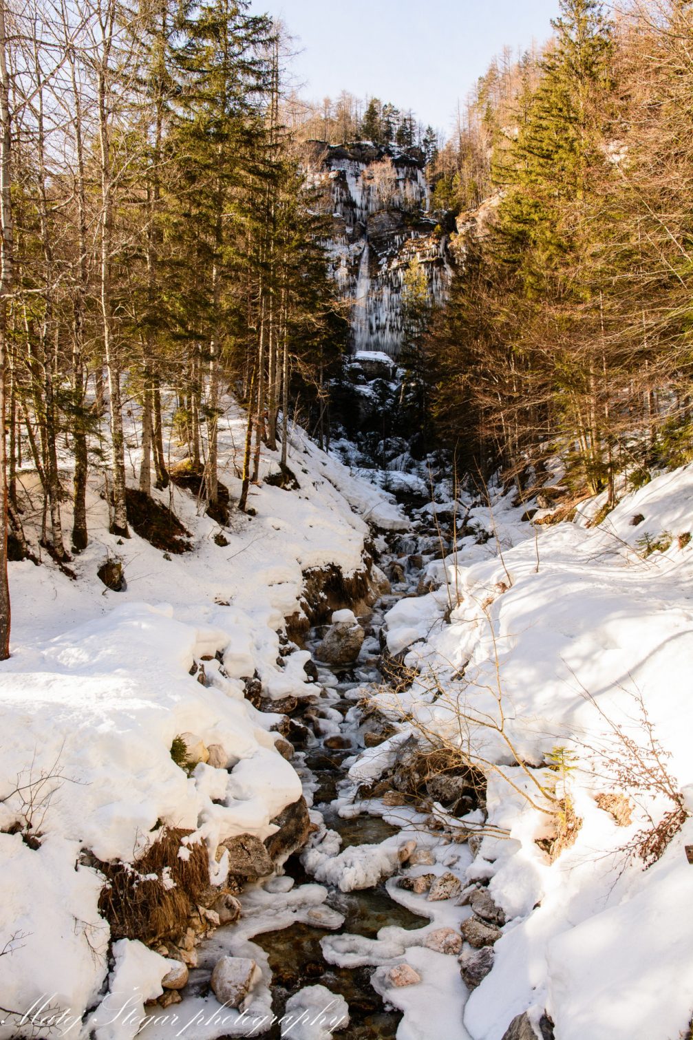 View of frozen Pericnik Waterfall in Triglav National Park from afar in winter