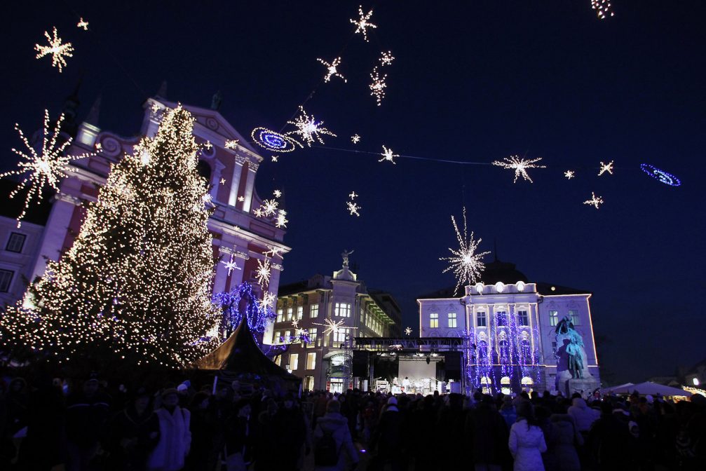 A Christmas Tree in Ljubljana with the pink Franciscan Church in the background