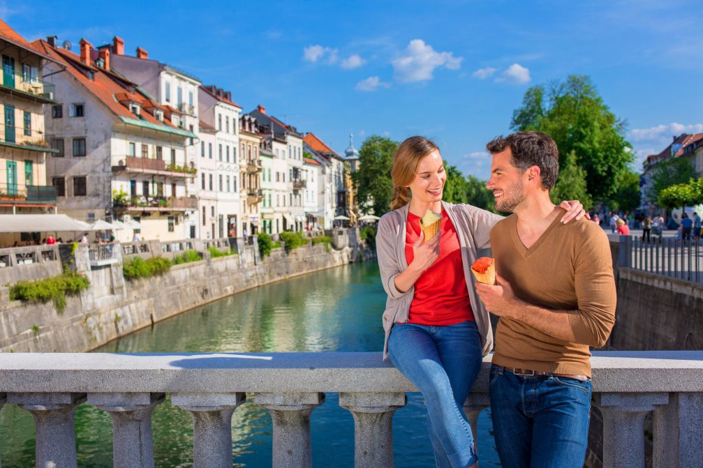 A couple eating ice cream on Cobblers Bridge in Ljubljana